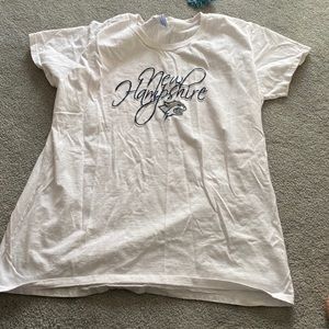 Two New Hampshire shirts, white s/s x/l with UNH logo, the other is l/s purple L